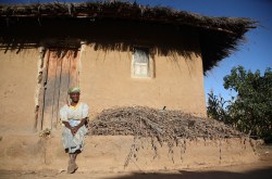 Khulungira villager sitting in fron of home