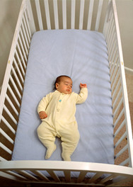 Baby Sleeping Alone in Crib on his Back