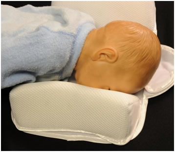 Doll face down in sleep positioner