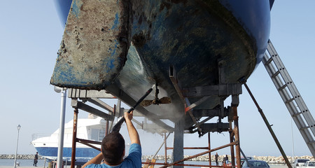 https://stock.adobe.com/images/man-cleaning-the-bottom-of-a-sailboat-with-high-pressure-water/200691448