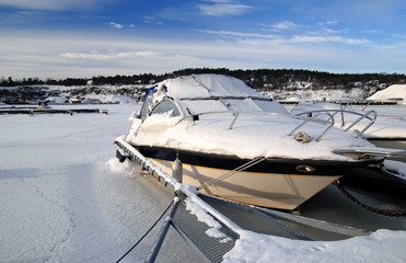 https://stock.adobe.com/images/frozen-motorboat-in-winter-harbor/28797139