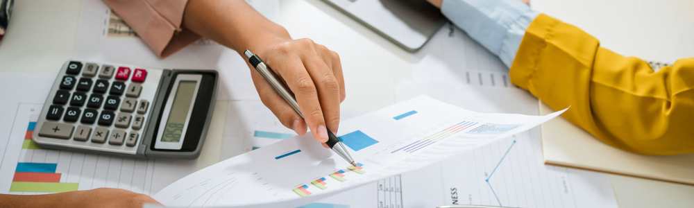 woman pointing to a graph on paper