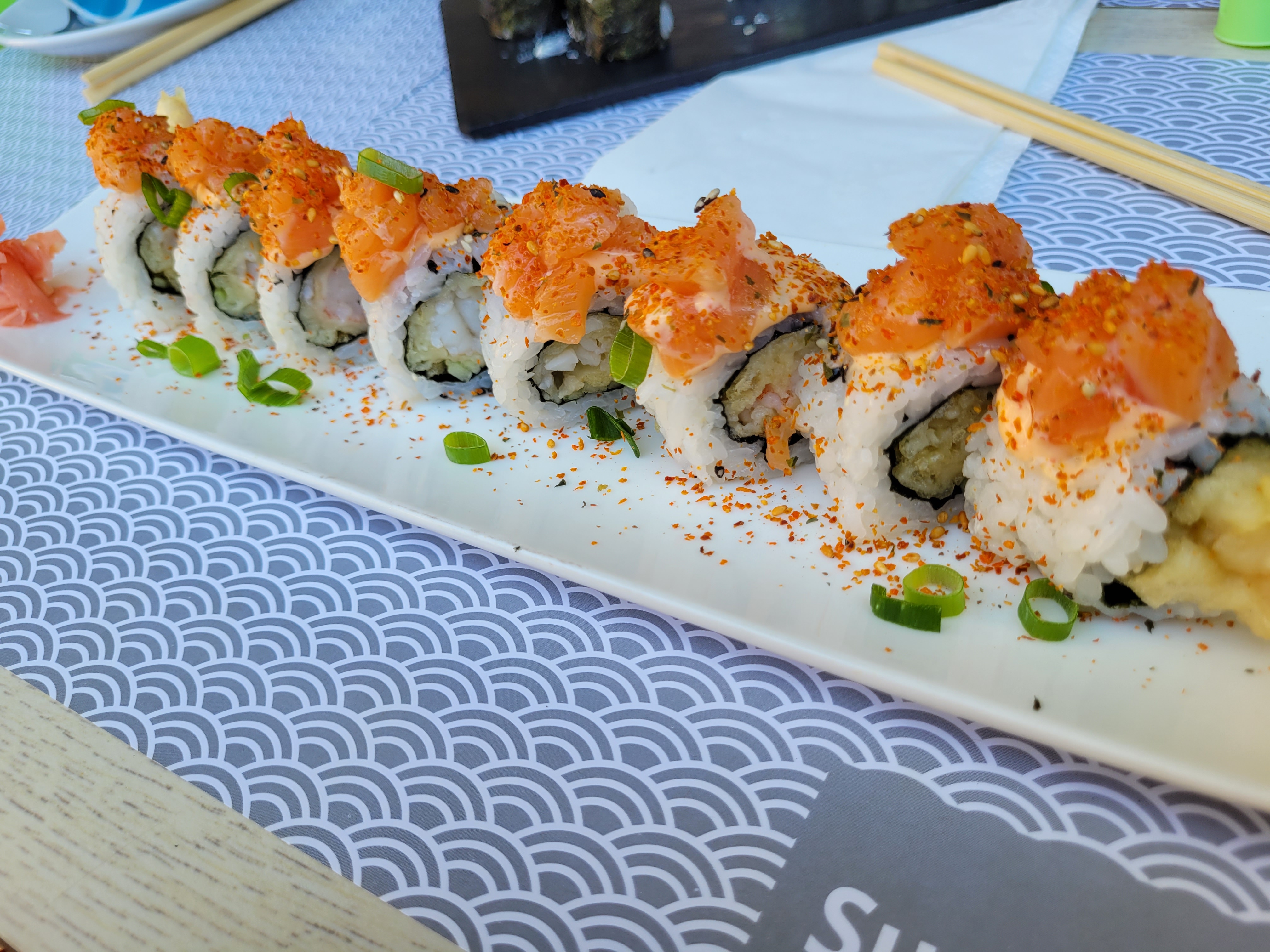 Sushi topped with sashimi and red flakes