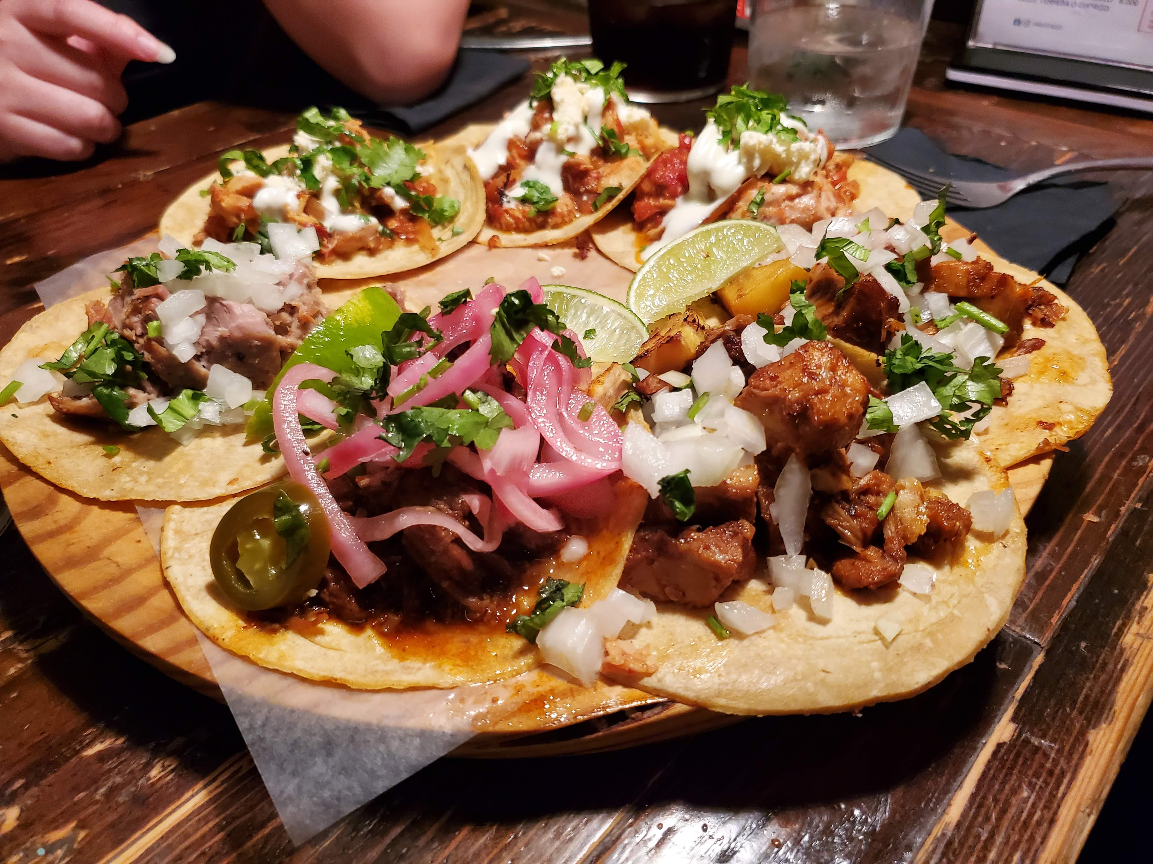 Plate of Tacos served with pickled onions, jalapenos, and lime