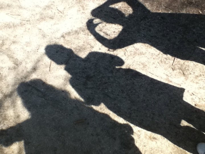 Shadowed people making figures with there fingers. Supposed to symbolize the members of World Peace Website.