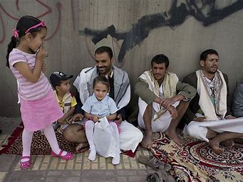A Yemeni family smiling, despite their living conditions